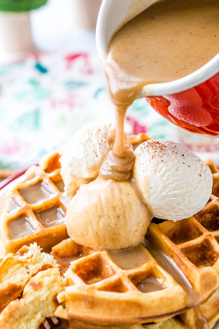 Eggnog Waffles are crisp and golden on the outside and fluffy on the inside, topped with whipped cream and spiced vanilla syrup!