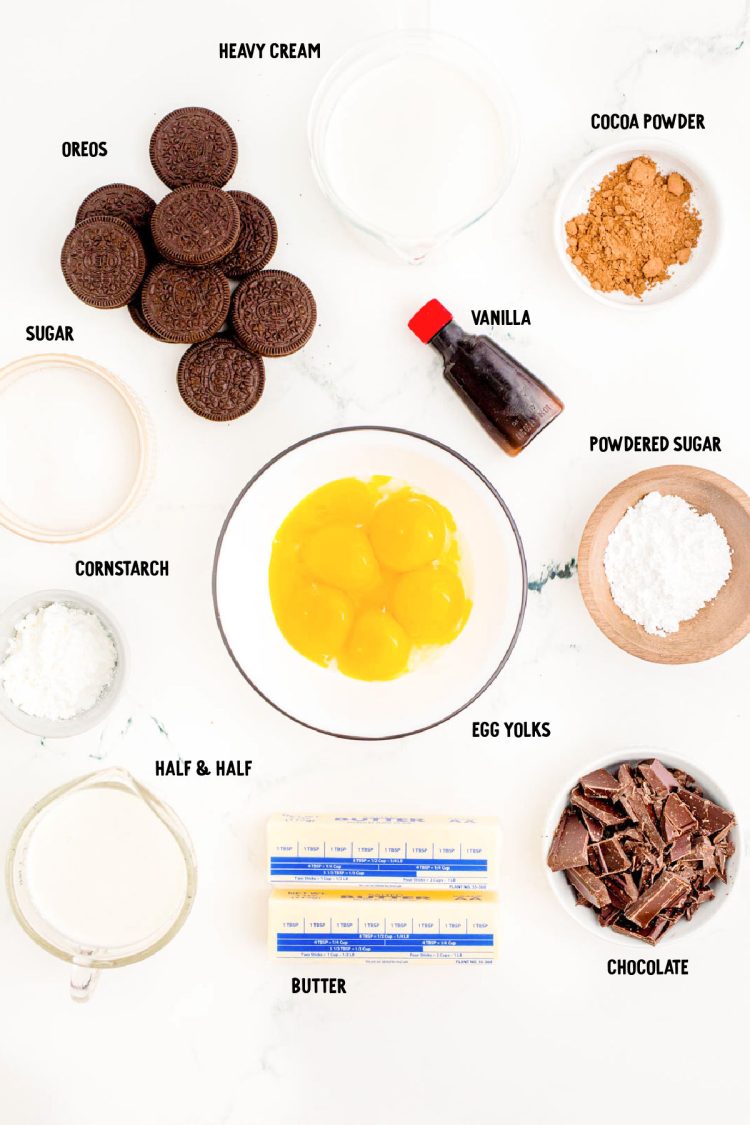 Ingredients to make chocolate cream pie from scratch on a marble surface.