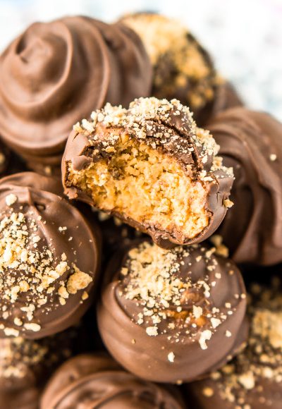 Peanut Butter Balls are a classic no-bake treat made with graham crackers, creamy peanut butter, powdered sugar, and chocolate! Perfect for the holidays!