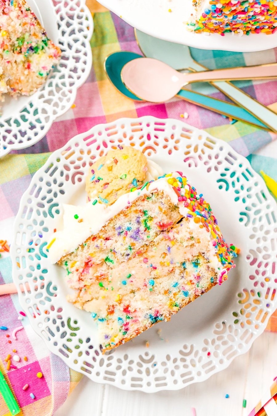 This Funfetti Sugar Cookie Dough Cake is an over the top cake made with two layers of white almond cake loaded with sprinkles and a layer of edible sugar cookie dough, then topped with classic vanilla buttercream!