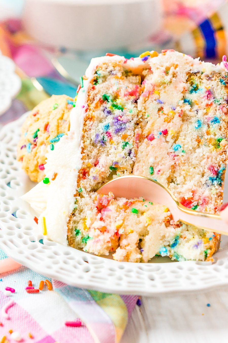 This Funfetti Sugar Cookie Dough Cake is an over the top cake made with two layers of white almond cake loaded with sprinkles and a layer of edible sugar cookie dough, then topped with classic vanilla buttercream!