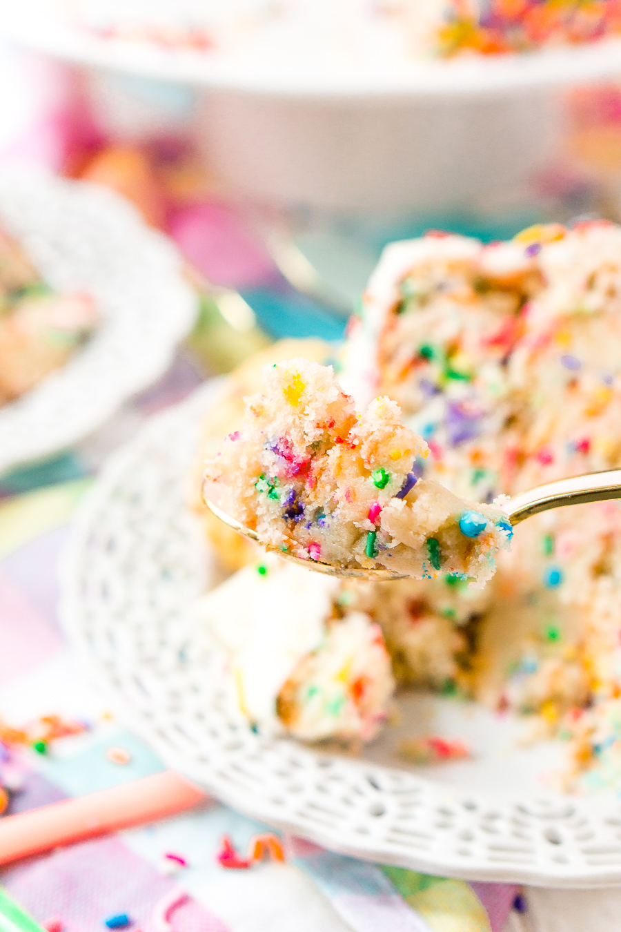 This Funfetti Sugar Cookie Dough Cake is an over the top cake made with two layers of white almond cake loaded with sprinkles and a layer of edible sugar cookie dough, then topped with classic vanilla buttercream!