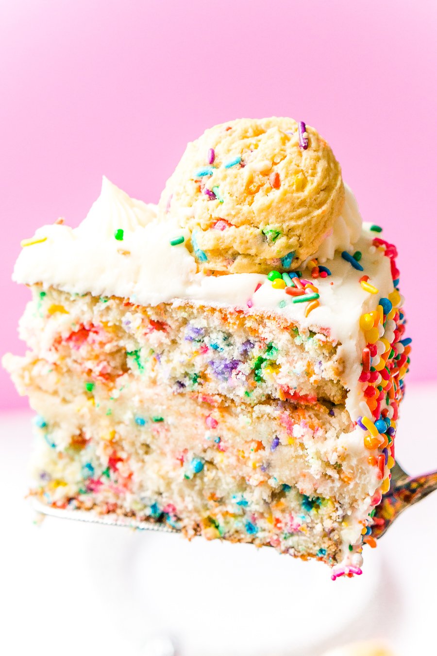 This Funfetti Sugar Cookie Dough cake is an over the top cake made with two layers of white almond cake loaded with sprinkles and a layer of edible sugar cookie dough, then topped with classic vanilla buttercream!