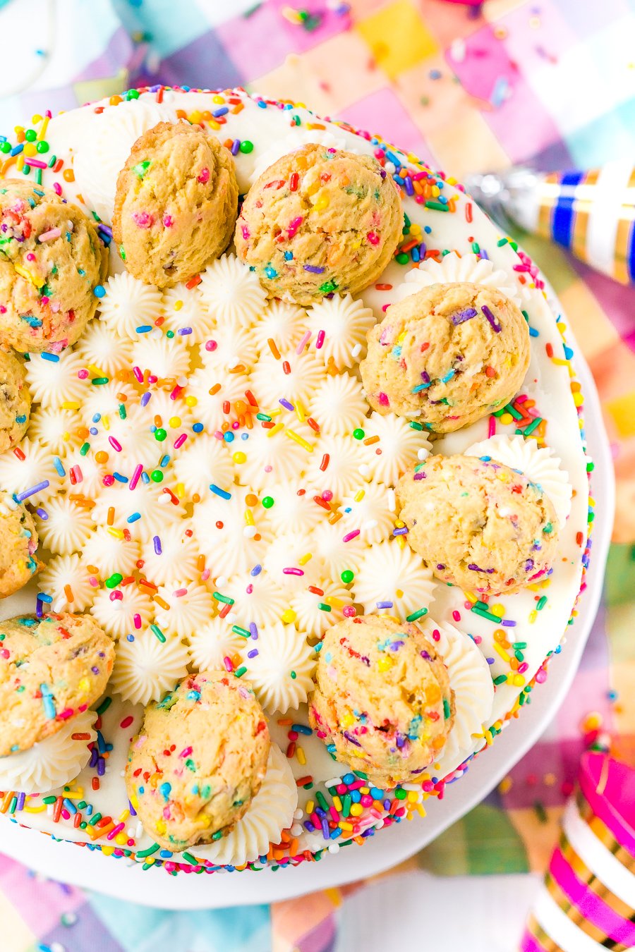 This Funfetti Sugar Cookie Dough Cake is an over the top cake made with two layers of white almond cake loaded with sprinkles and a layer of edible sugar cookie dough, then topped with classic vanilla buttercream!