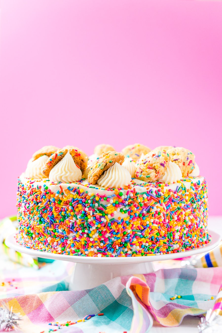 This Funfetti Sugar Cookie Dough Cake is an over the top cake made with two layers of white almond cake loaded with sprinkles and a layer of edible sugar cookie dough, then topped with classic vanilla buttercream!