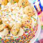 This Funfetti Sugar Cookie Dough Cake is an over the top cake made with two layers of white almond cake loaded with sprinkles and a layer of edible sugar cookie dough, then topped with classic vanilla buttercream!