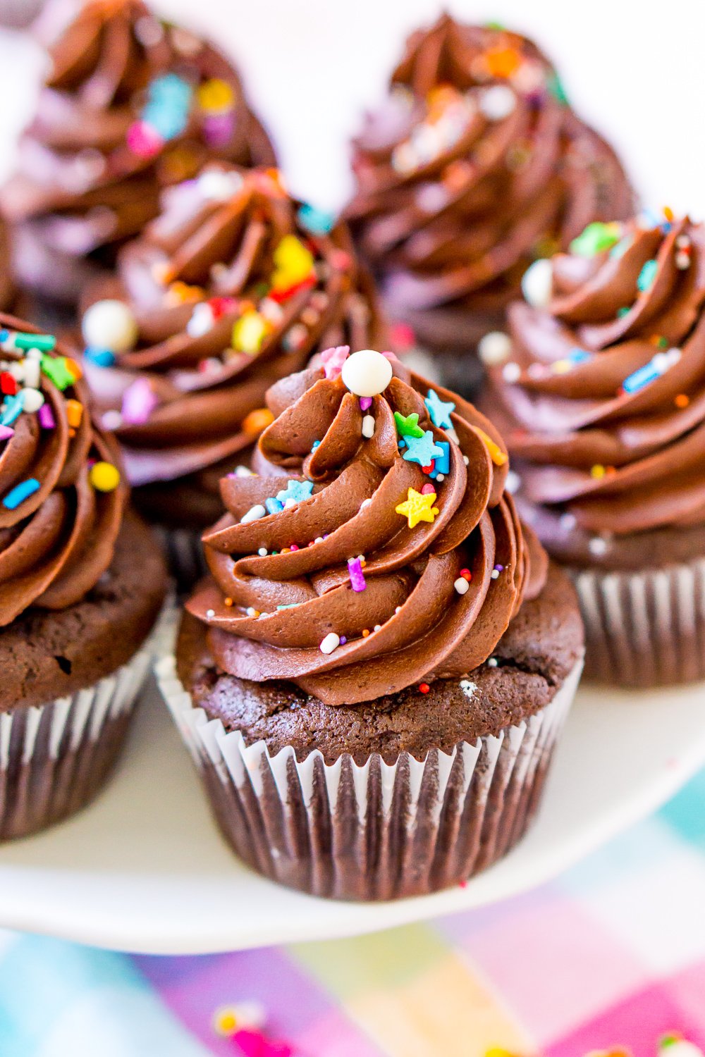 Chocolate Cupcakes on a white cake stand.