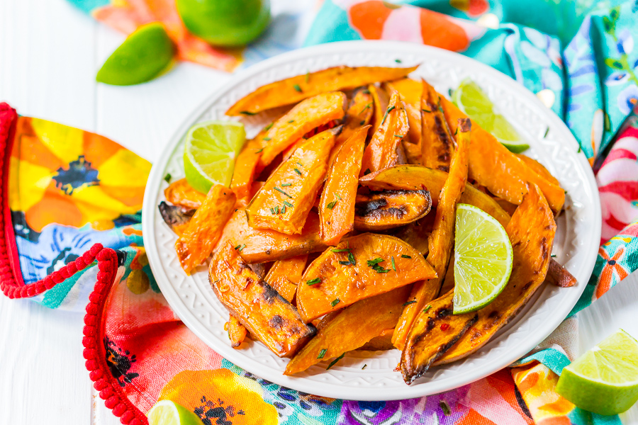 Chile Lime Sweet Potato Wedges are lighter than fries and potato skins, but just as delicious. With a squeeze of lime, a dash of garlic, and a kick of chile, this side is so flavorful, you won’t miss the extra calories!