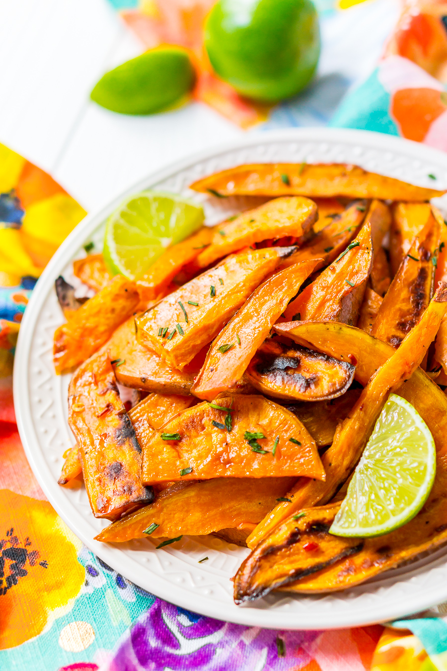 Chile Lime Sweet Potato Wedges are lighter than fries and potato skins, but just as delicious. With a squeeze of lime, a dash of garlic, and a kick of chile, this side is so flavorful, you won’t miss the extra calories!