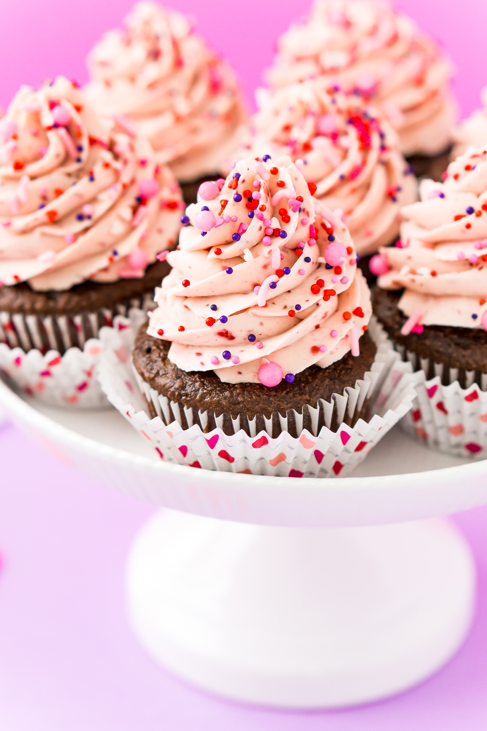 These Strawberry Chocolate Cupcakes are a delicious blend of rich chocolate cake and sweet strawberry whipped cream frosting! Perfect for Valentine's Day, Baby Showers, Bridal Showers, and more!