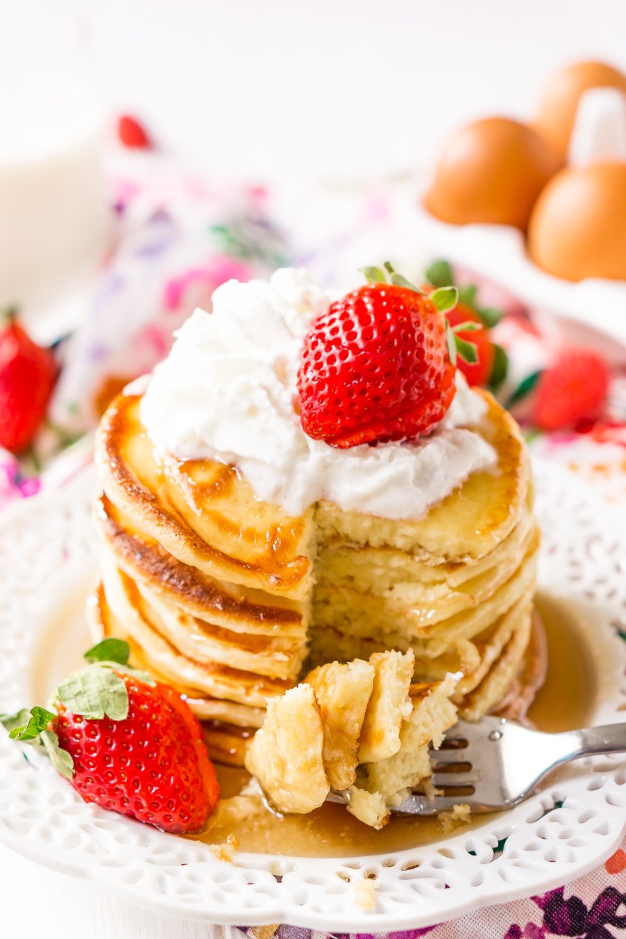 Cream Cheese Pancakes with slice taken out of stack with bite on fork.