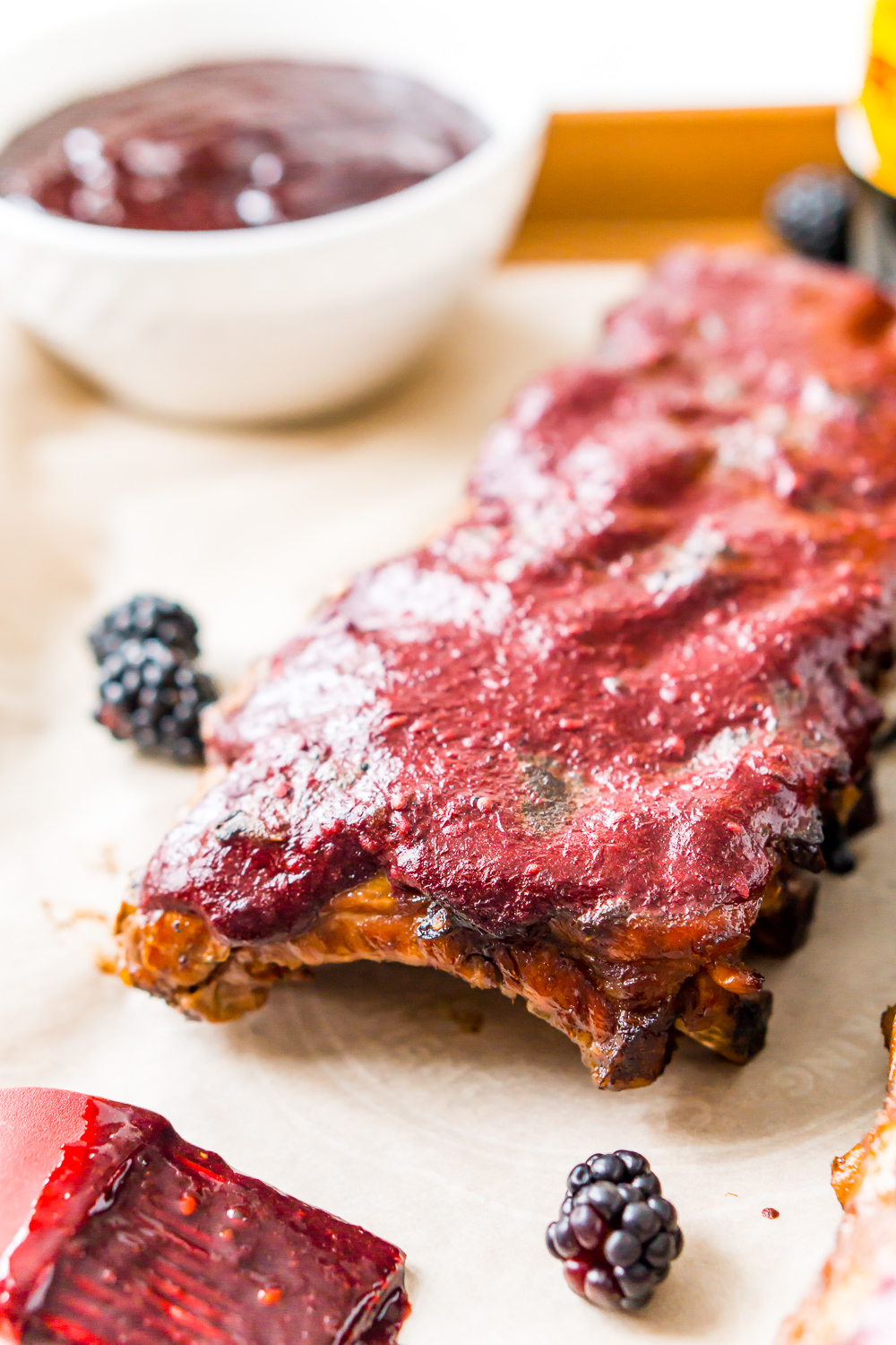 Baby back ribs on sheet pan with blackberry barbecue sauce