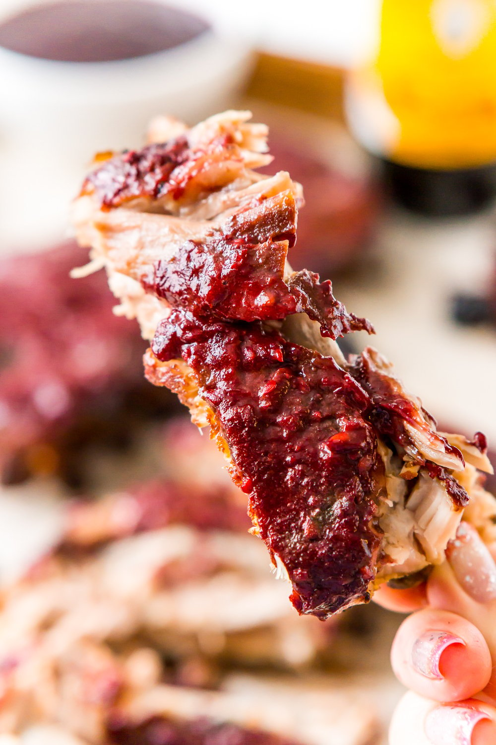 These Crock Pot Ribs are juicy, tender, and full of flavor! Easy to make and messy to eat, these baby back ribs are smothered in a sweet blackberry barbecue sauce! Perfect for game days!