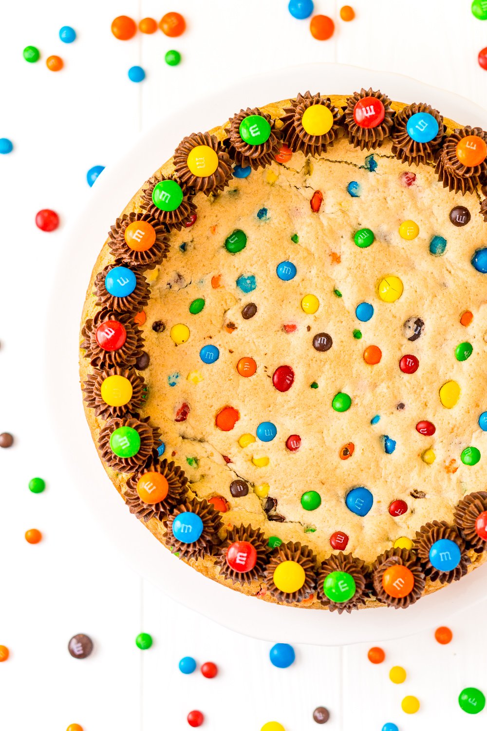 Overhead of M&M's Cookie Cake on white background.