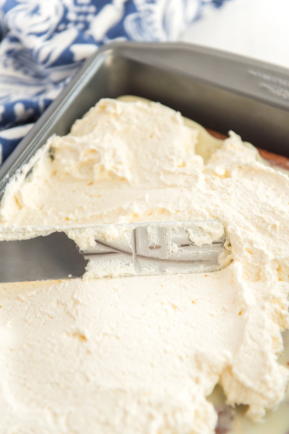 Frosting a Caramel Carrot Cake with cheesecake frosting.