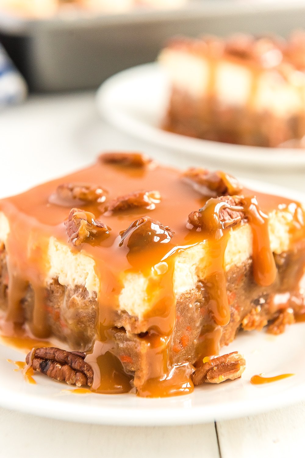 Slice of Caramel Carrot Cake Poke Cake on a white plate.