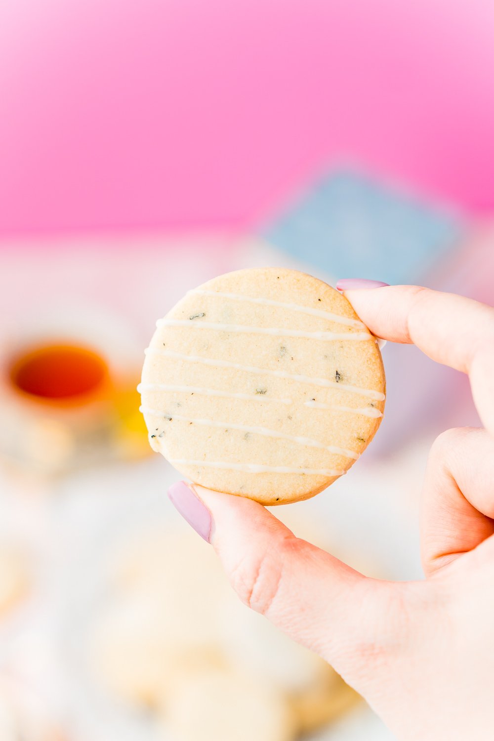 Woman's hand holding an Earl Grey Shortbread Cookie.