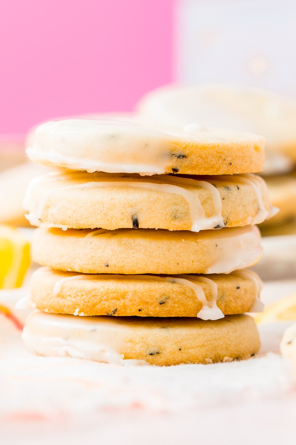 Stack of five Earl Grey Shortbread Cookies with pink background.