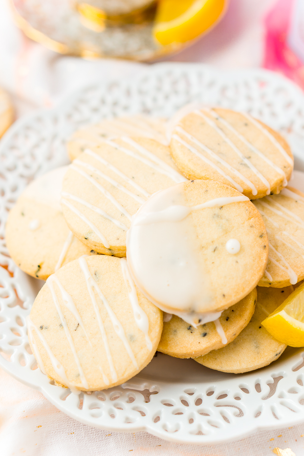 White plate full of Earl Grey Shortbread Cookies with lemon glaze.