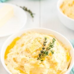 These are The Best Creamy Mashed Potatoes you'll ever make and super easy too! They're loaded with butter, milk, and cream and flavored with garlic and thyme and a touch of salt and pepper!