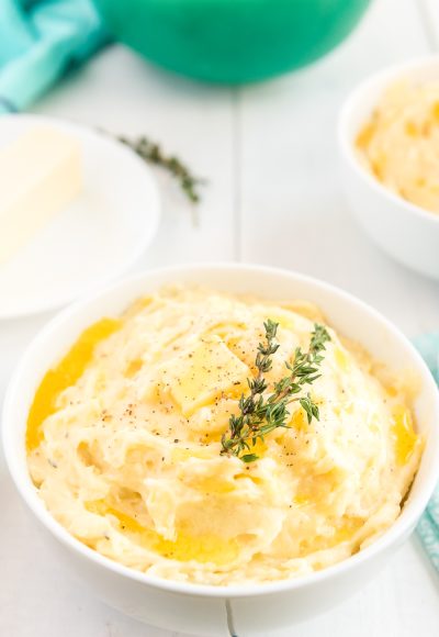 These are The Best Creamy Mashed Potatoes you'll ever make and super easy too! They're loaded with butter, milk, and cream and flavored with garlic and thyme and a touch of salt and pepper!