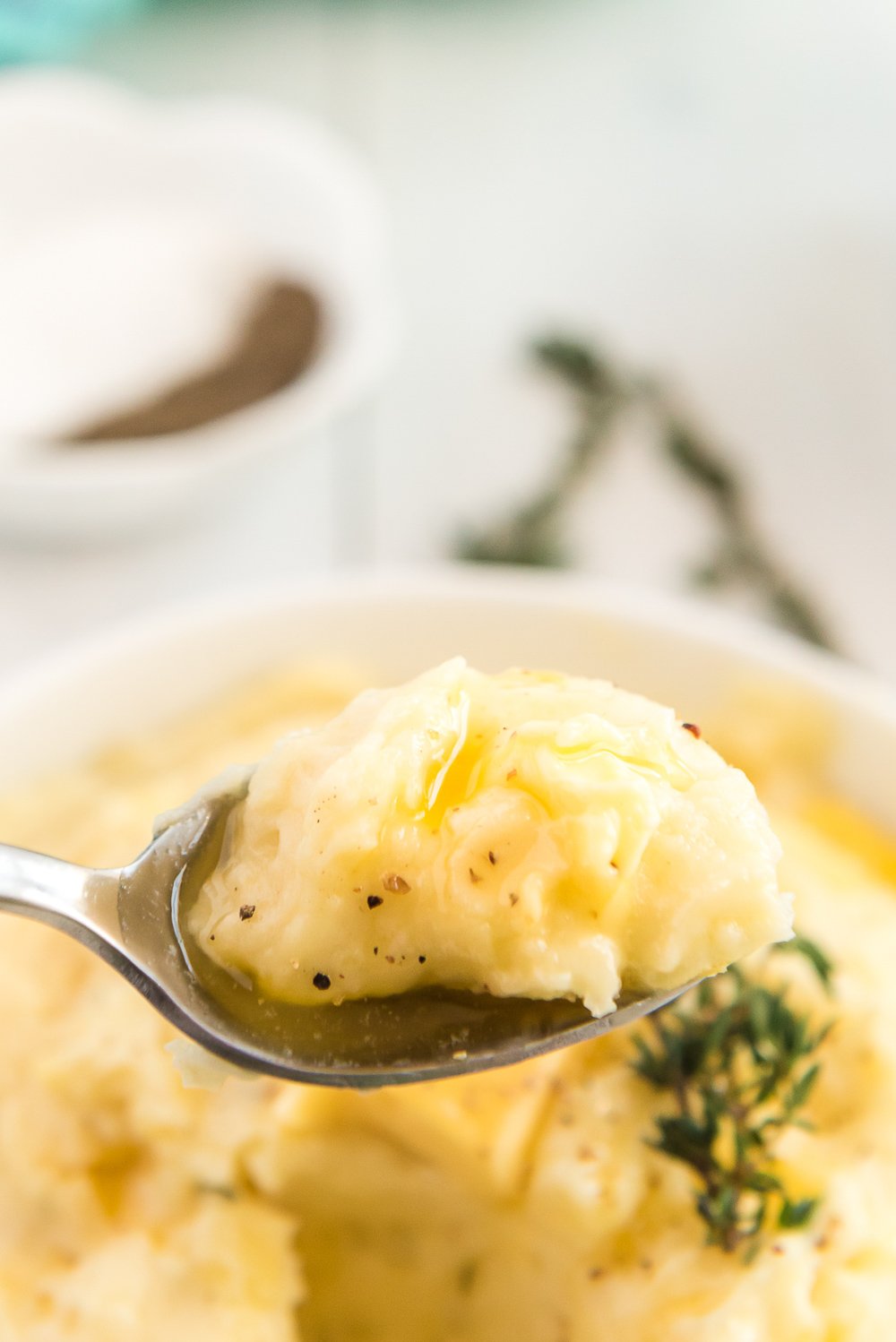 Close up photo of a spoonful of Homemade Mashed Potatoes.