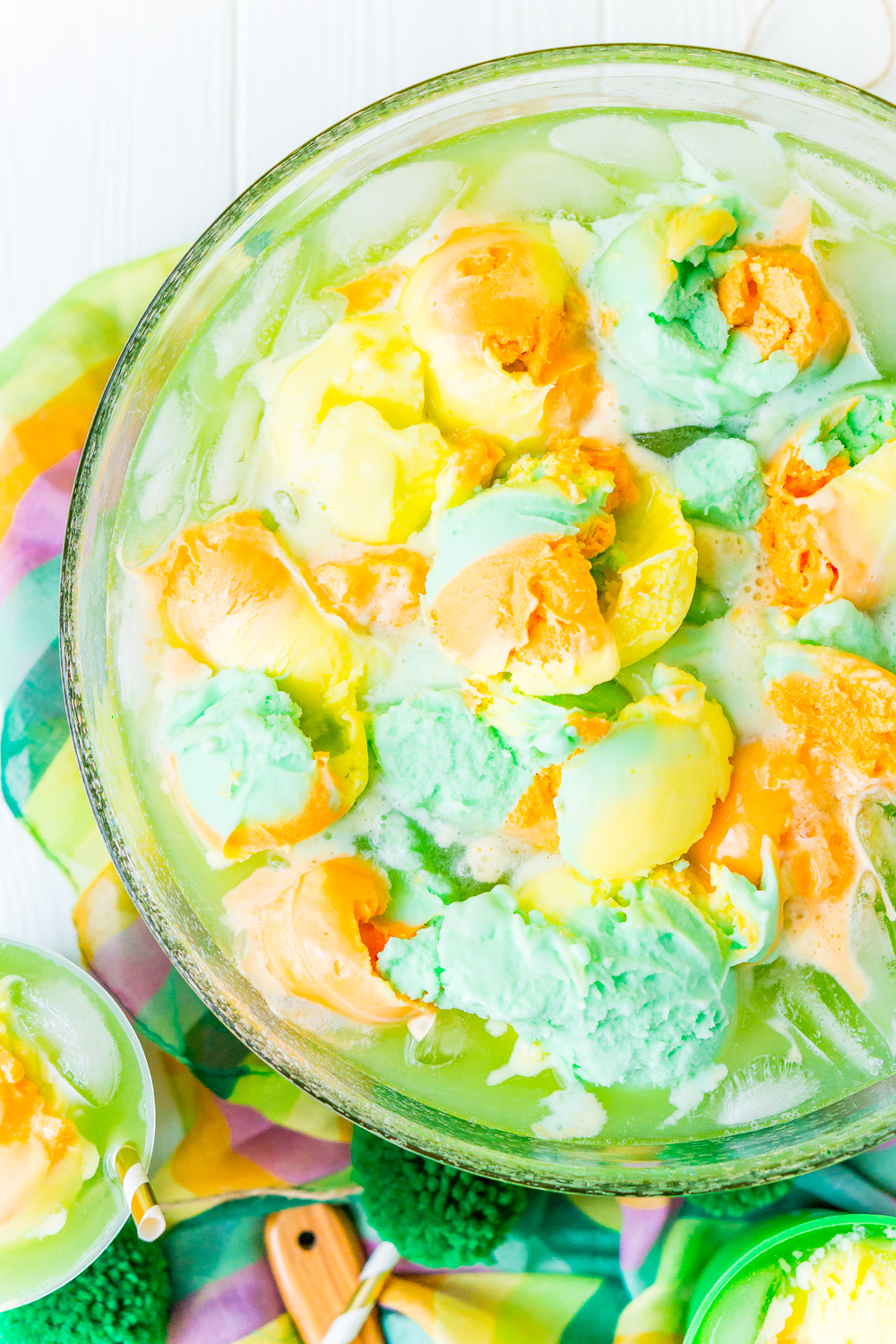 Overhead photo of a punch bowl filled with St. Patrick's Day Punch that's topped with rainbow sherbet.