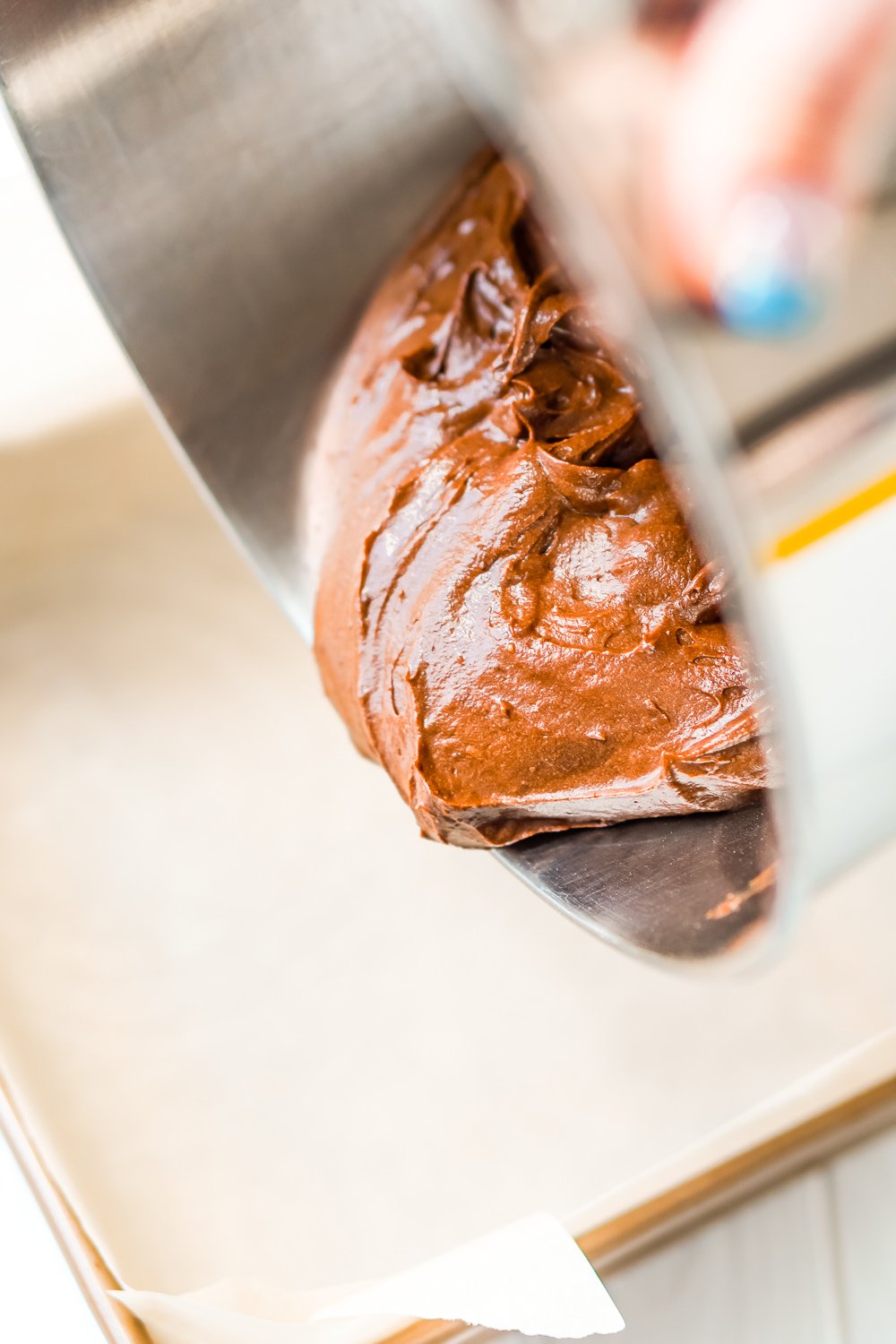 Brownie batter being poured into a baking pan