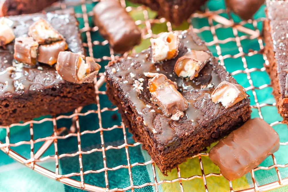 These Twix Caramel Brownies are a delicious cake-like chocolate brownie with Twix candy bars baked in, then drizzled with caramel and topped with more candy bar crumbles.