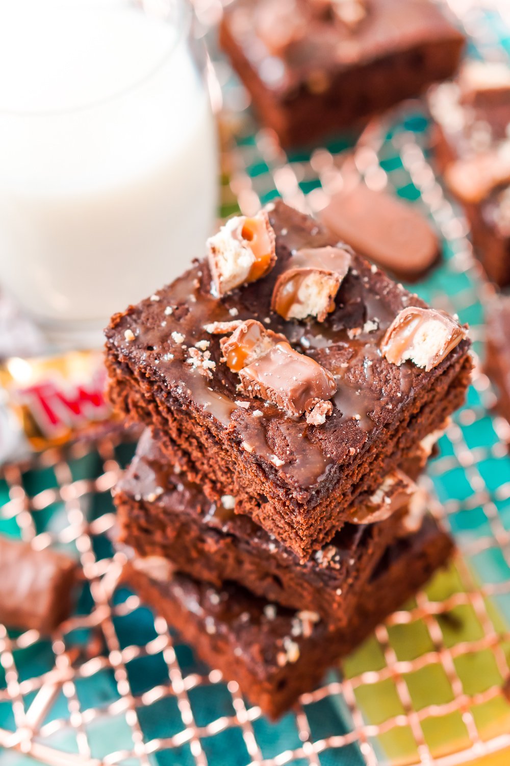 These Twix Caramel Brownies are a delicious cake-like chocolate brownie with Twix candy bars baked in, then drizzled with caramel and topped with more candy bar crumbles.