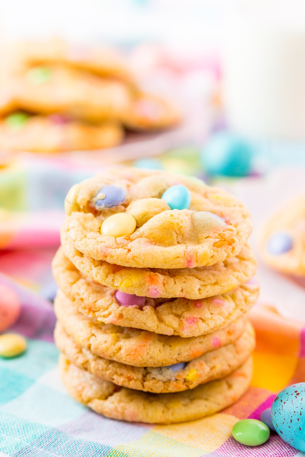 Close up photo of a stack of M&M cookies.