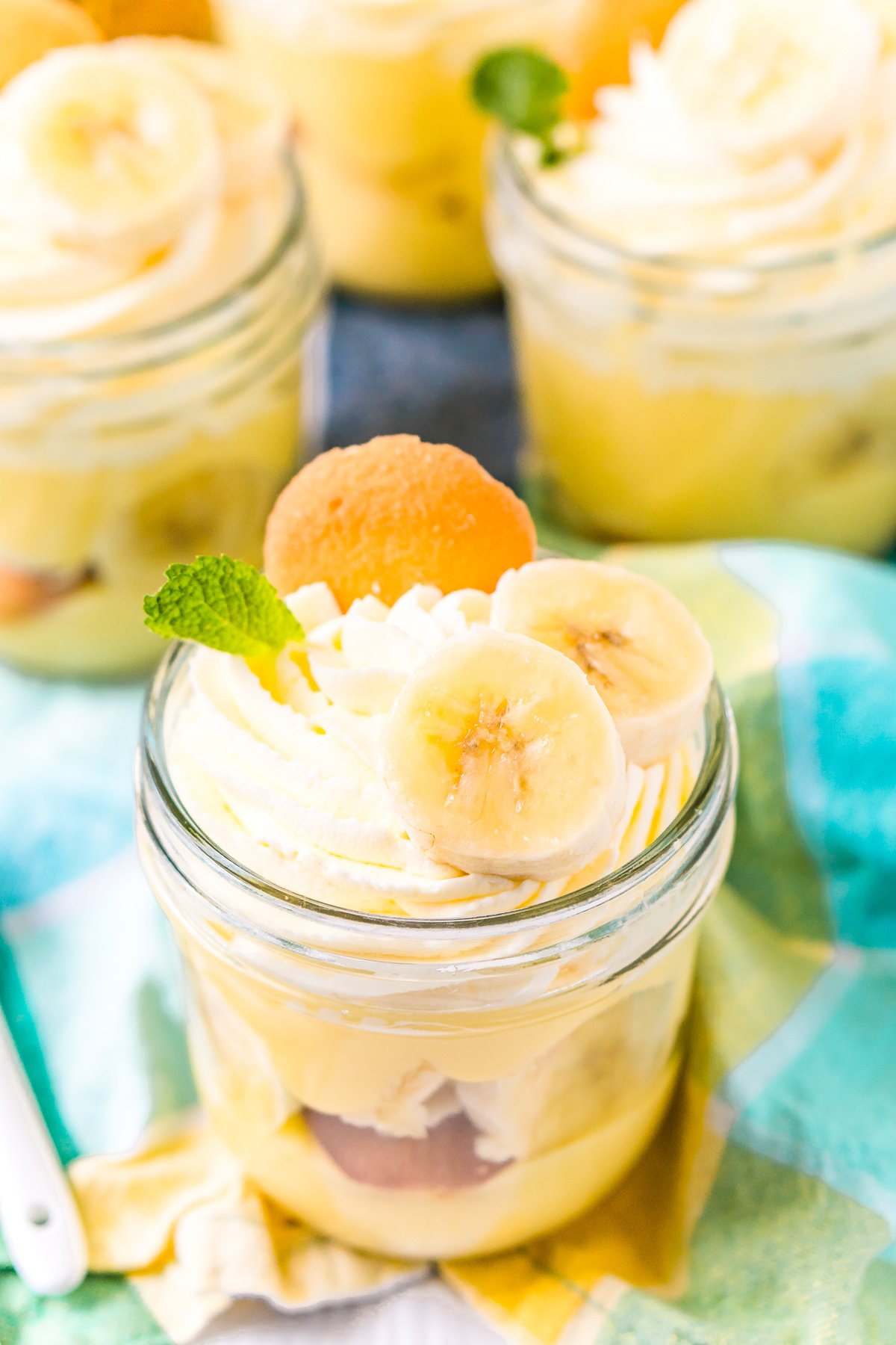 Mini mason jars filled with banana pudding dessert.