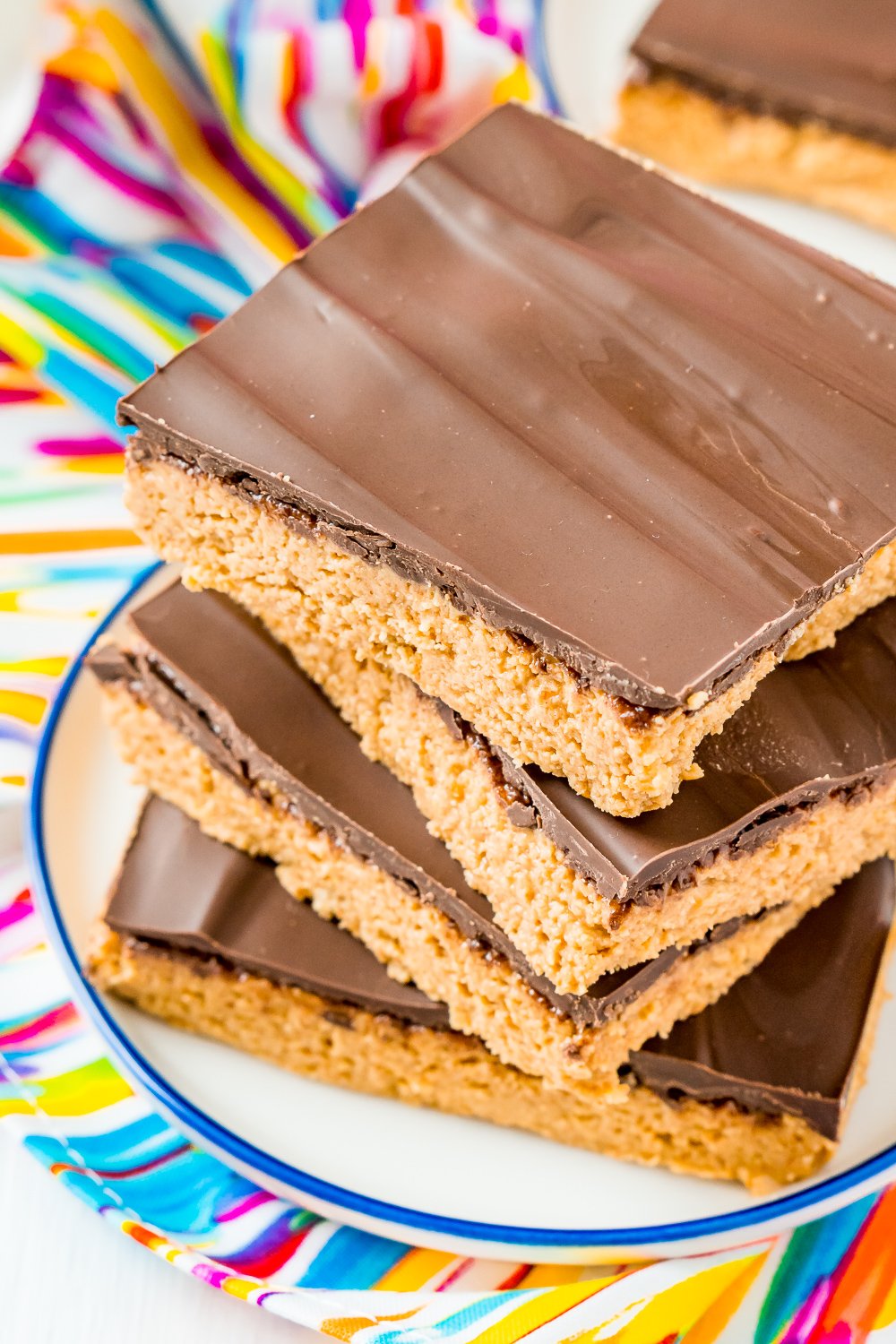 Peanut Butter Bars are a classic, 5-ingredient dessert recipe that can be made in less than 10 minutes! Made with a blend of peanut butter, graham crackers, powdered sugar, butter, and chocolate!