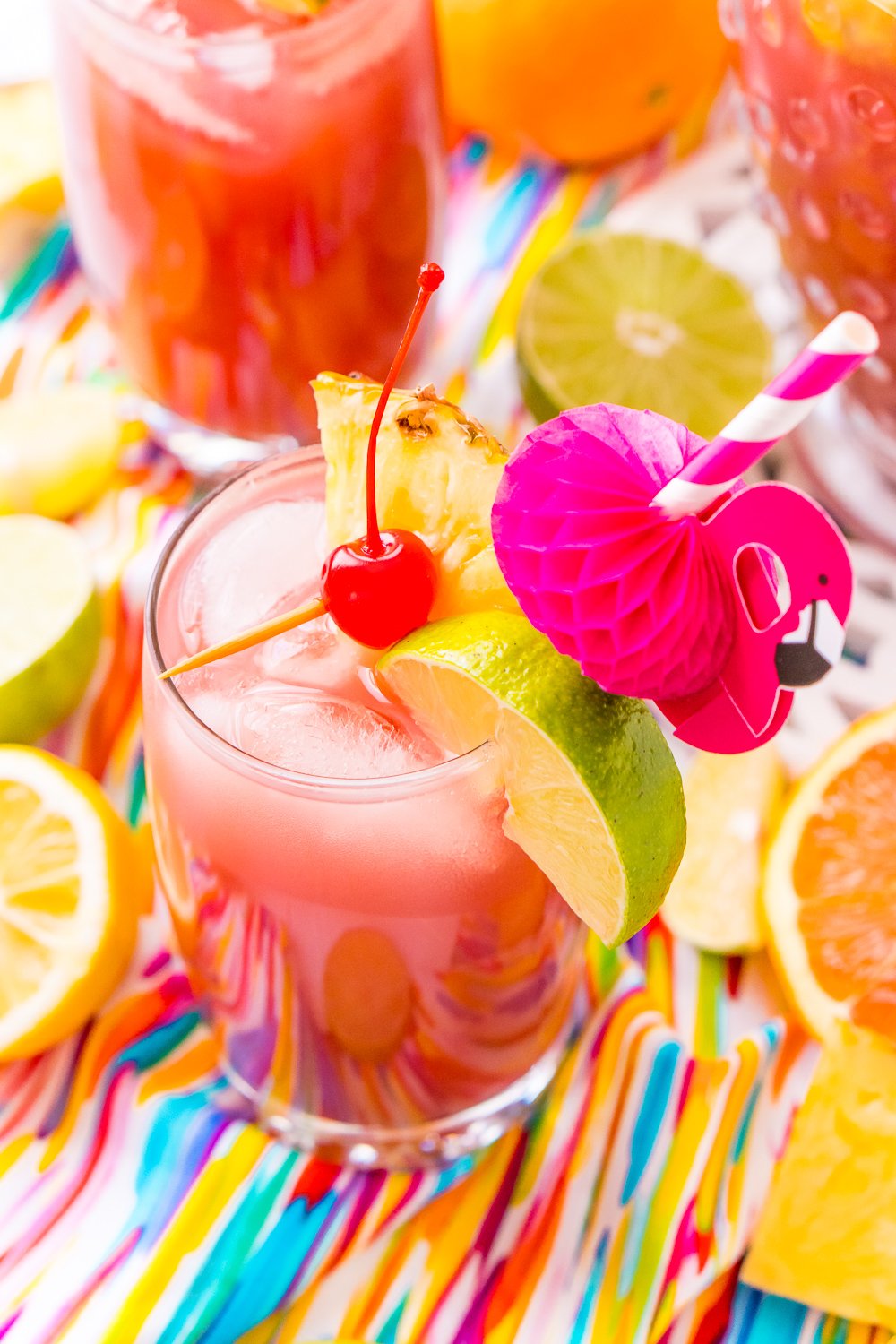 Rum Punch combines orange, pineapple, cranberry, lime, and lemon juice with ginger ale and three different kinds of rum for a delicious large batch Caribbean inspired cocktail for summer parties!