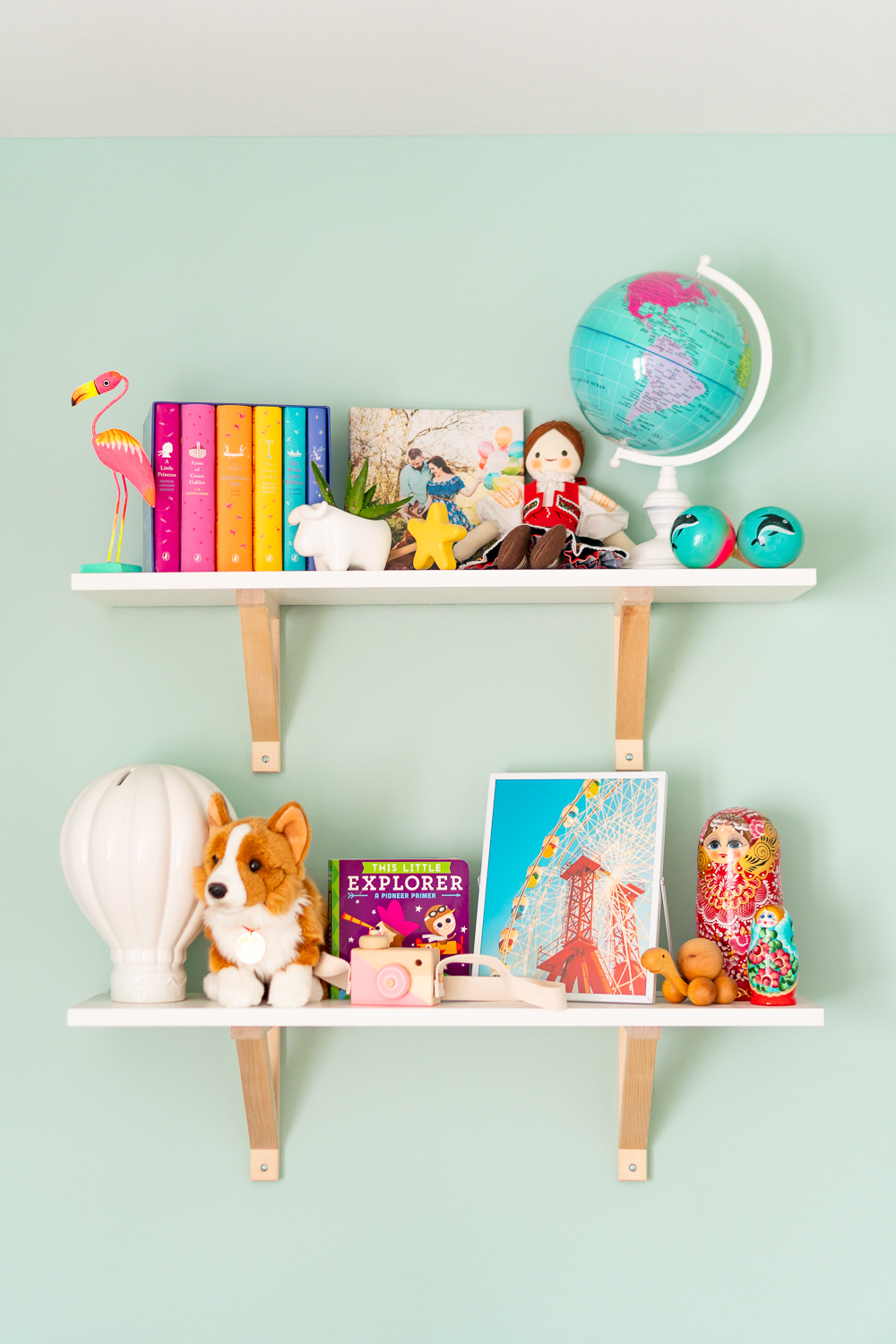 Travel inspired nursery decorations on shelves