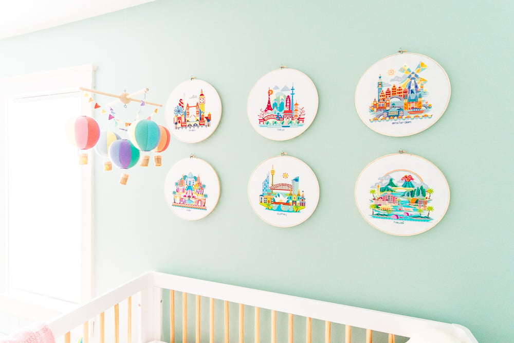 Six needlepoint circular pieces depicting different cities around the world 