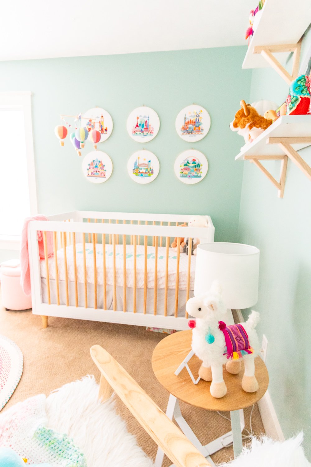 Crib and shelves filled with stuffed animals