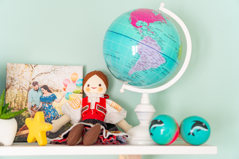 Travel inspired decor on shelf for nursery