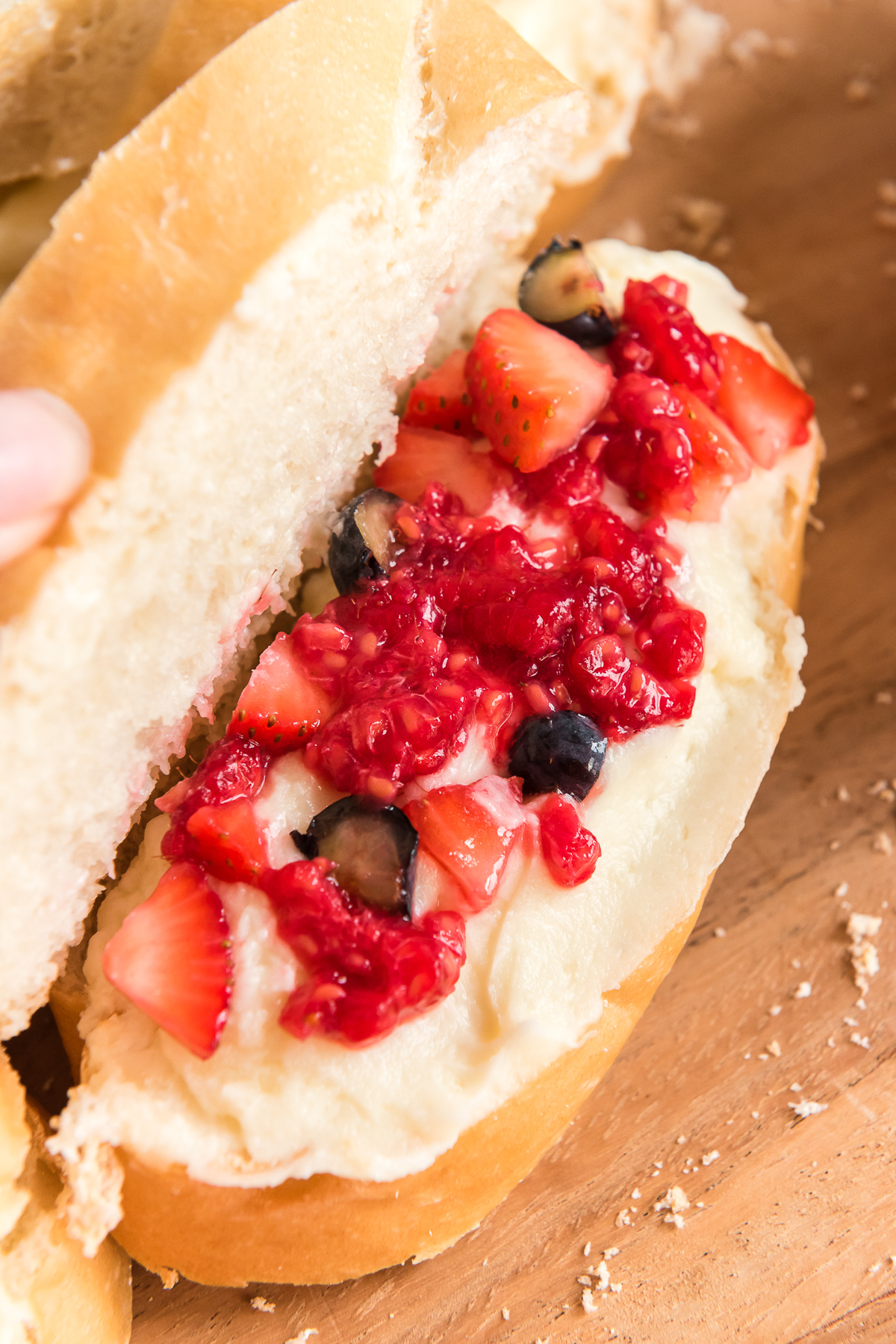 Macerated berries and mascaprone cheese filling on french bread slices.