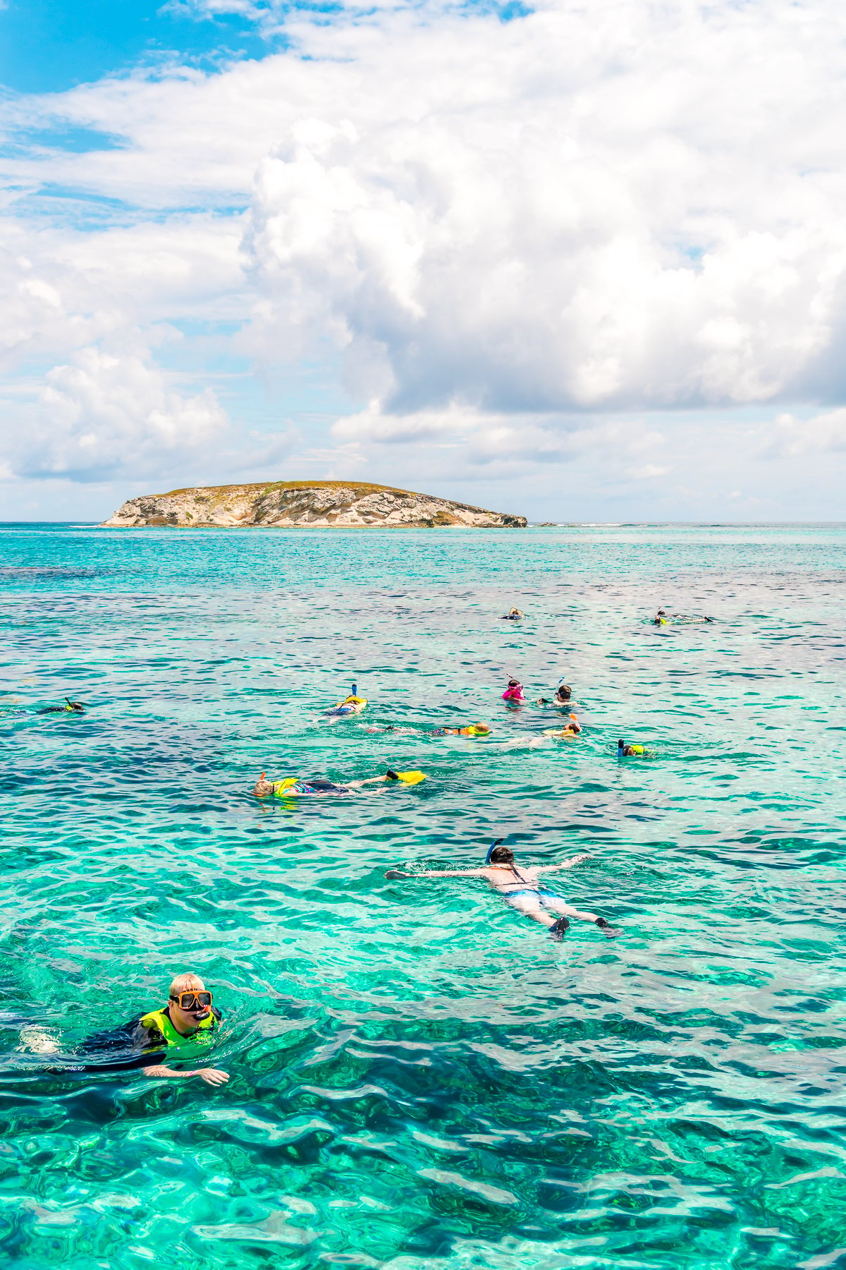 People snorkeling in the clear turquoise waters of Grand Turk in the Caribbean.