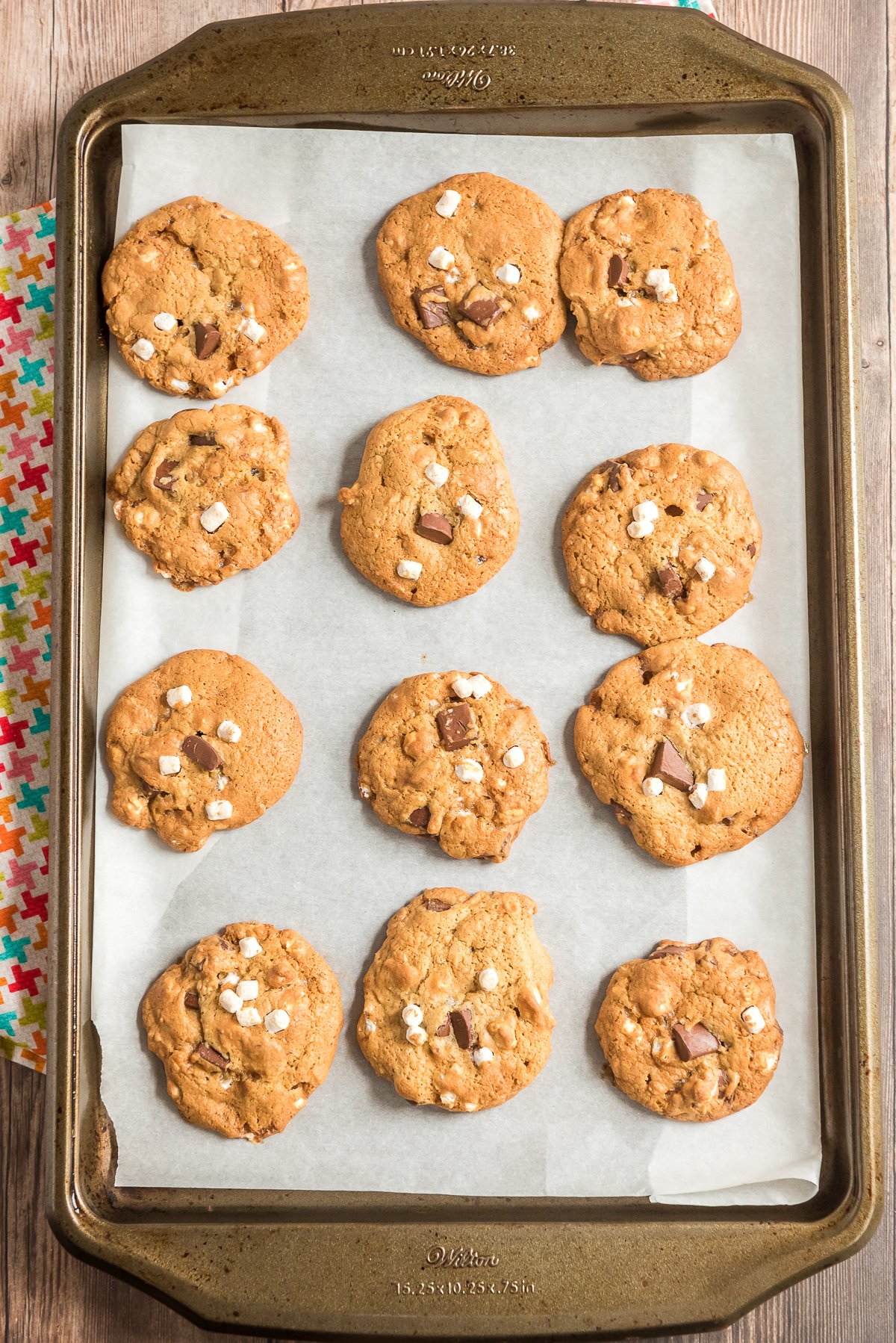 Baked cookies on a parchment lined baking sheet.