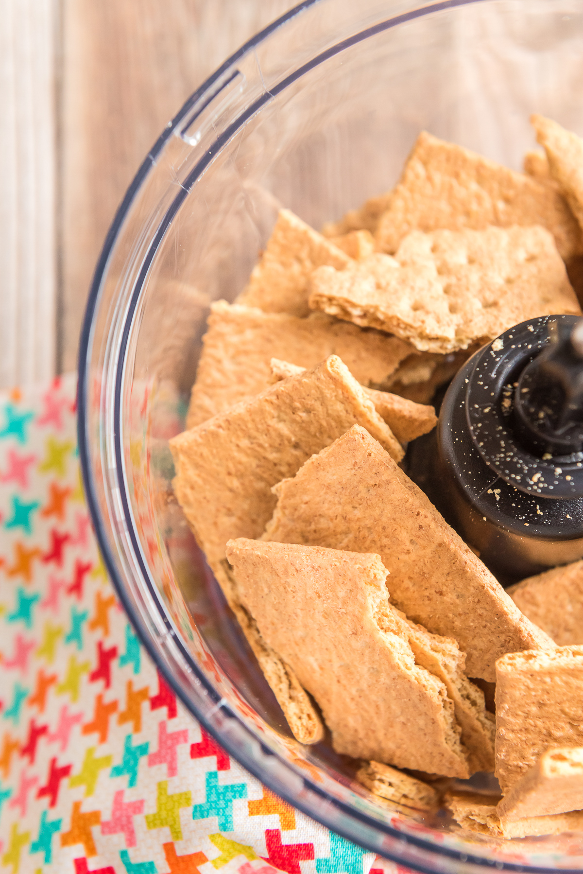 Graham crackers in a food processor getting ready to be blended.