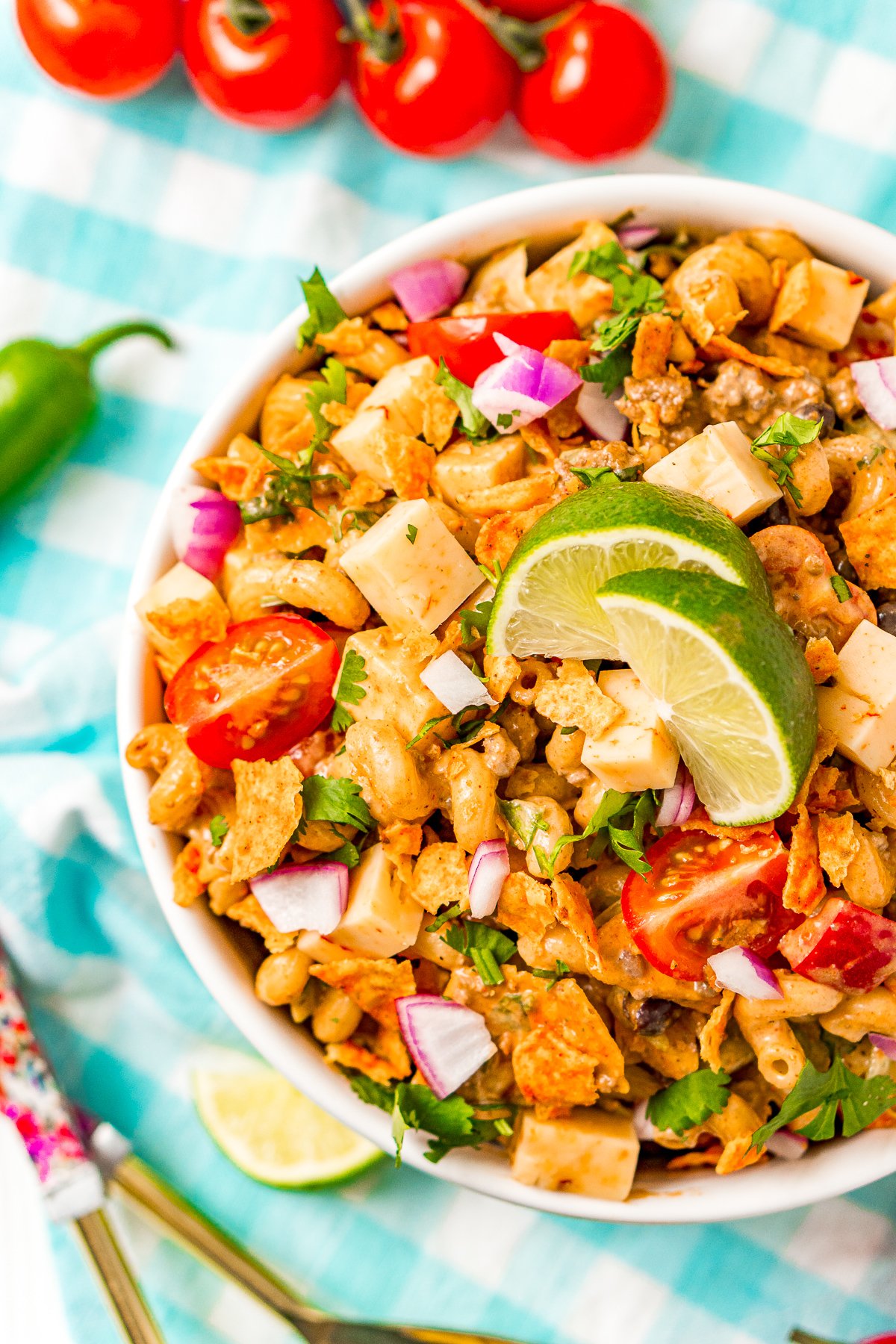 Overhead shot of a pasta salad in a white bowl with taco flavors.