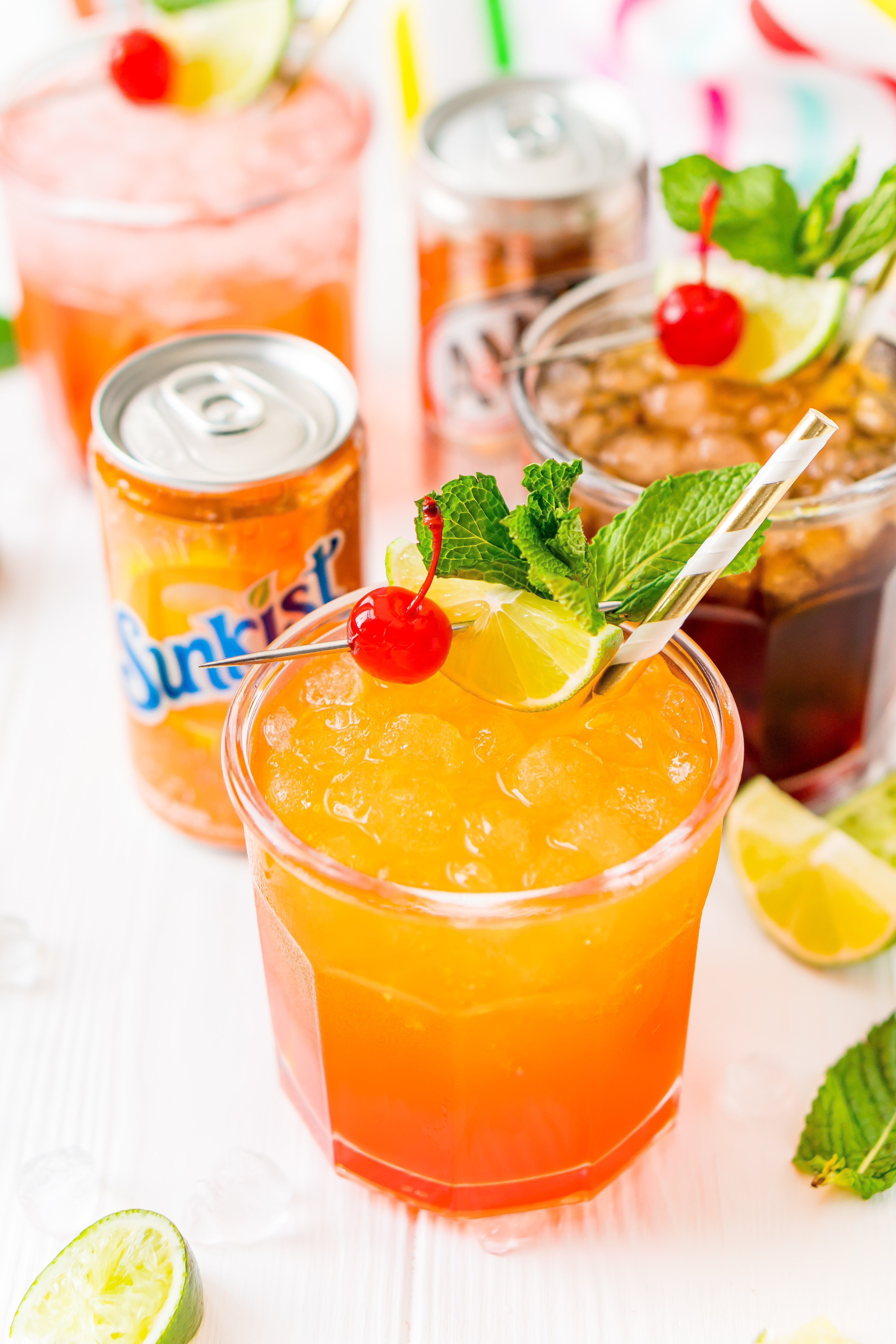 Orange soda mocktail in a glass with a can of orange soda next to it