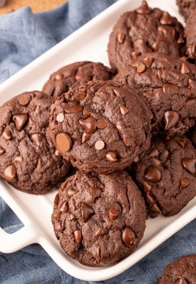 Overhead photo of double chocolate chip cookies on a white serving tray.