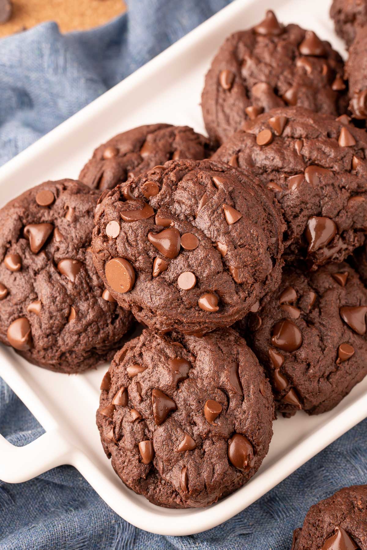 Overhead photo of double chocolate chip cookies on a white serving tray.