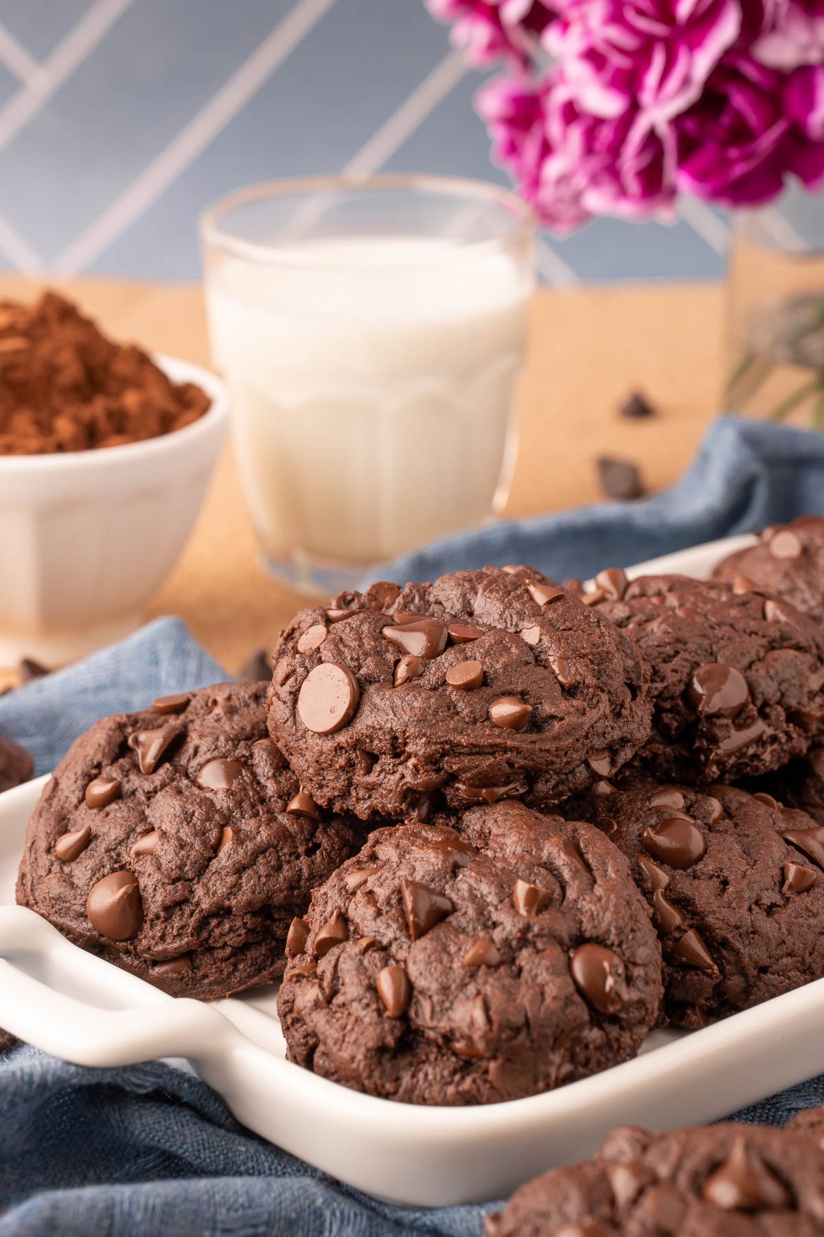 Double Chocolate Chip Cookies on a white serving tray on a blue napkin.