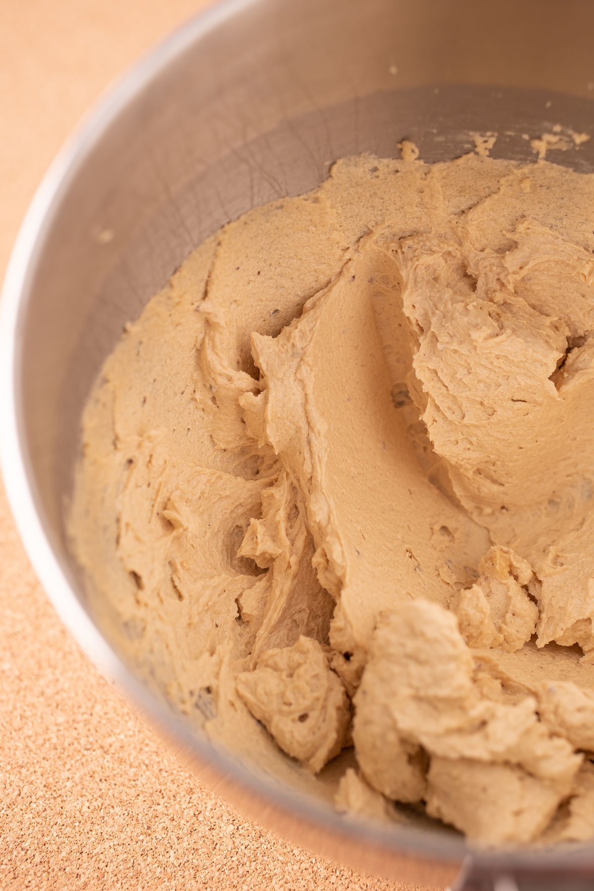 Butter, sugar, and eggs creamed together in a stand mixer bowl.