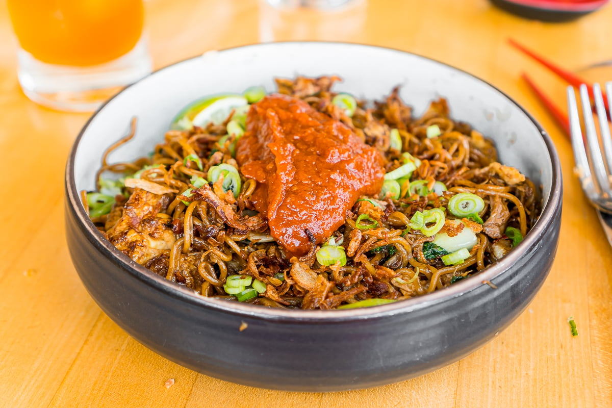 pork & crab mee goreng in a black bowl at The Honey Paw, an Asian fusion restaurant in Portland, ME