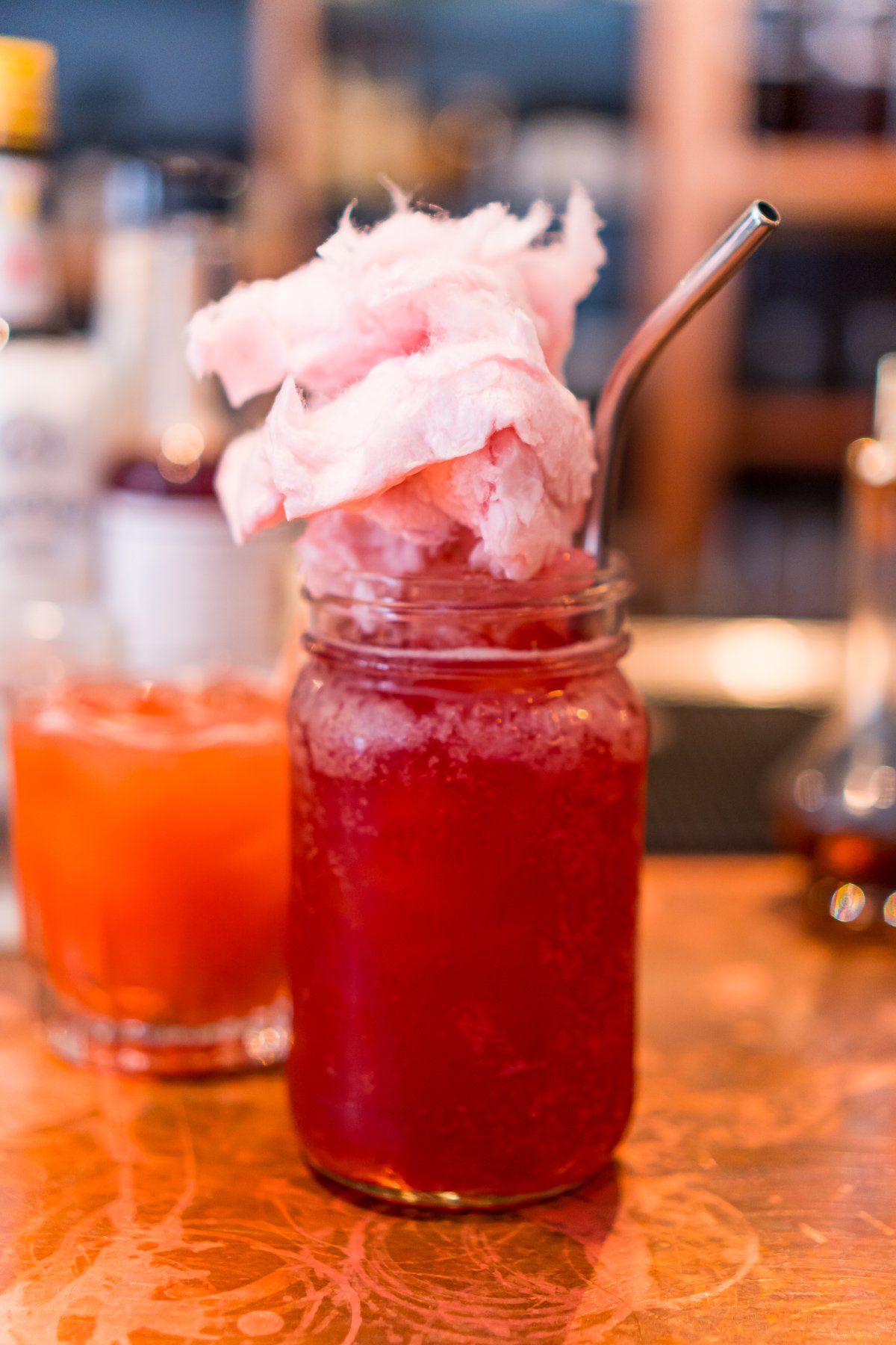 Cocktail served in a mason jar with cotton candy on top in Portland, Maine restaurant.